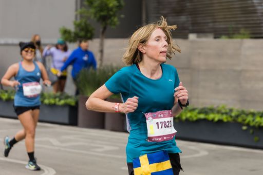 A woman running the International Marathon of Mexico city on the street