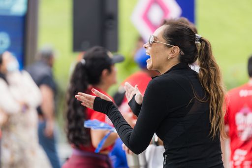 A woman cheering runners during the International Marathon of Mexico city on the street
