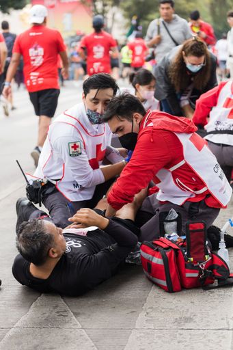 A group of paramedics attend an injured runner man during the International Marathon of Mexico