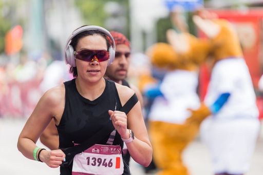 A woman running the International Marathon of Mexico city on the street