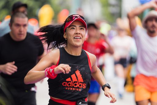 A woman running the International Marathon of Mexico city on the street