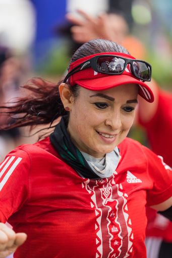 A woman running the International Marathon of Mexico city on the street