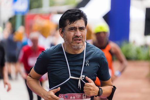 A man running the International Marathon of Mexico city on the street