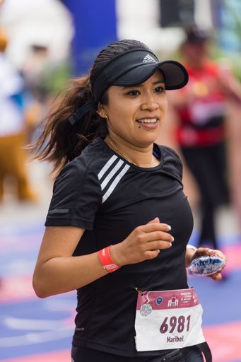 A woman running the International Marathon of Mexico city on the street