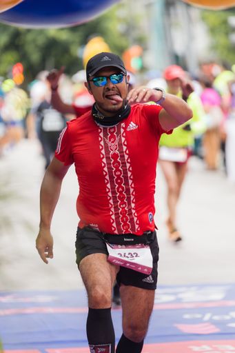 A man running the International Marathon of Mexico city on the street
