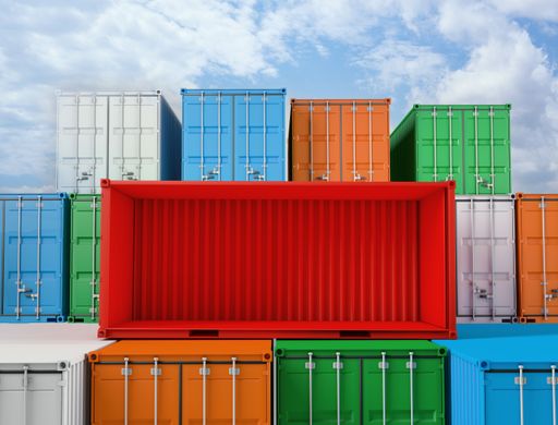 Colorful Cargo containers laid on each other under the blue sky