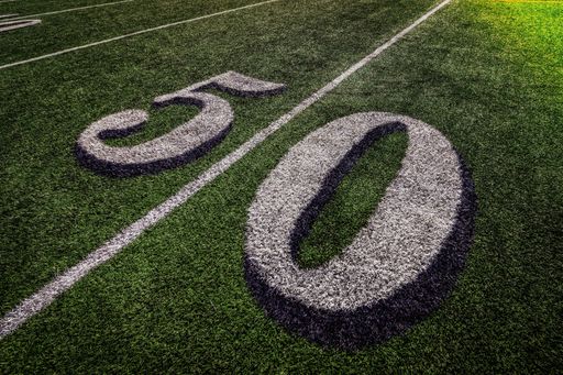 THe 50th yard line of the stadium with green lawn