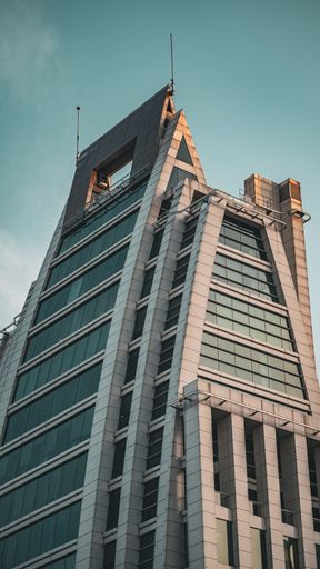 A vertical shot of a beautiful modern building with a blue sky in the background in Santiago, Chile