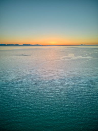 A vertical shot of a beautiful ocean view at sunset