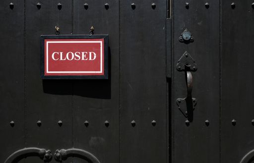 A close-up shot of a closed banner on a locked metallic door