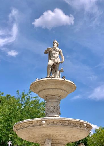 A vertical low angle shot of Danubius Fountain on blue cloudy sky background in Budapest, Hungary