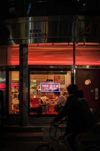 A vertical shot of neon sign of a cozy cafe at night in Seoul, South Korea