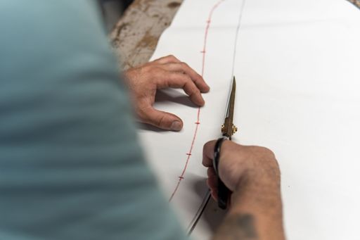 Upholsterer cutting pieces of leather with scissors to repair a seat, copy space