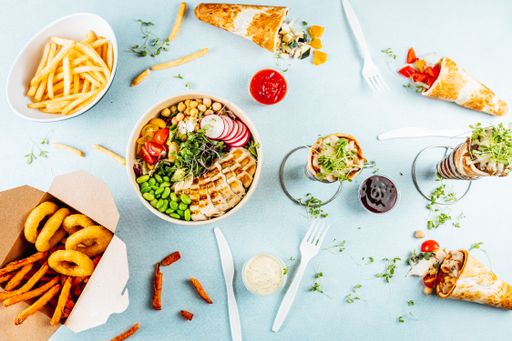 A flat lay of pizza cones and snack boxes