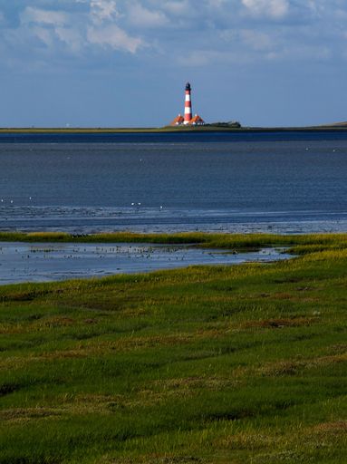 A vertical distant shot of famous Westerhever lighthouse located in St. Peter-Ording, Germany