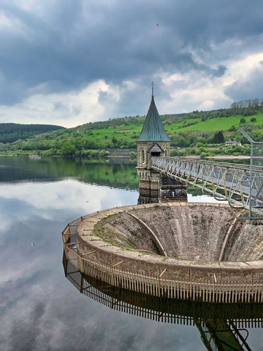A vertical shot of the Bell-mouth spillway and valve tower. Pontsticill Reservoir, south Wales, UK.
