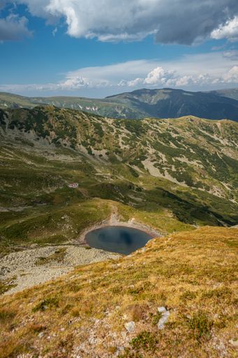 A vertical shot of a glacial lake located in the Fagaras Mountains, Romania.