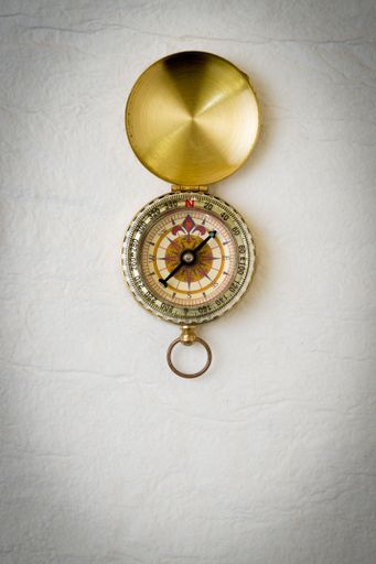A vintage compass on white handmade paper
