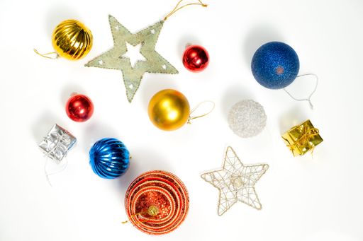 A top shot of New Year colorful balls and other decoration on the white background