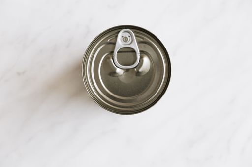 A top view of a tin can lid on a white background