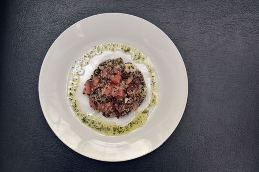 Three colors Quinoa salad with Avocados, Tomatoes and Onions with Olive oil, pepper and lemon sauce on top.