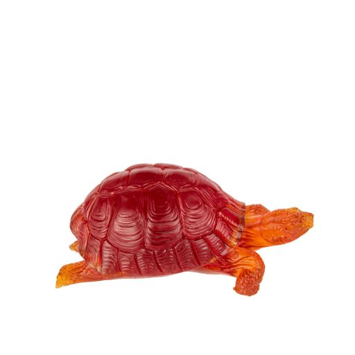 A red glass turtle on a white background - decoration for an interior