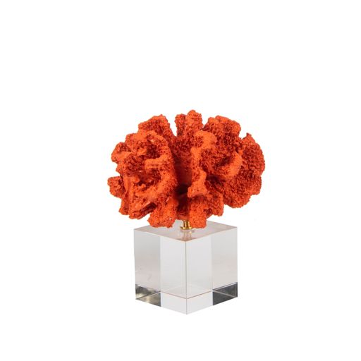 An abstract red coral figure accessory on a glass stand isolated on white background - decoration for an interior