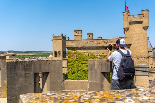 A closeup shot of a young man taking photos in a castle
