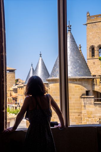 A vertical shot of a female in a castle in Navarra, Spain