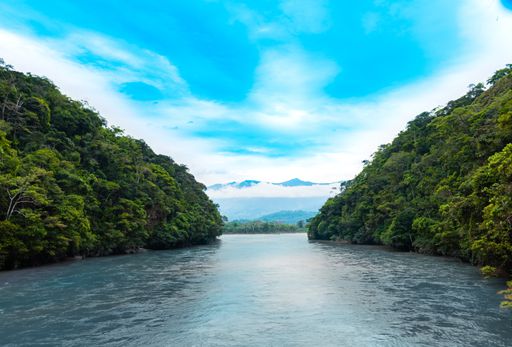 A beautiful shot of a river passing through between two islands on a clear sky background
