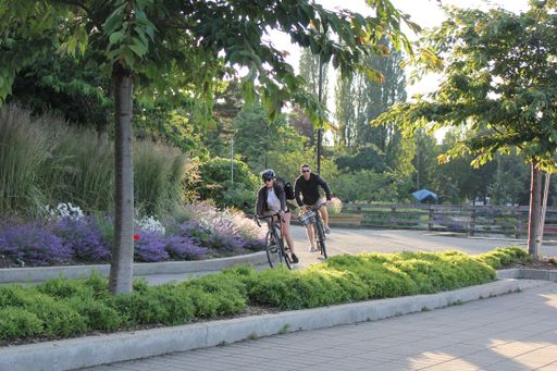 The young people a riding a bike on summer day in Vancouver, British Columbia, Canada
