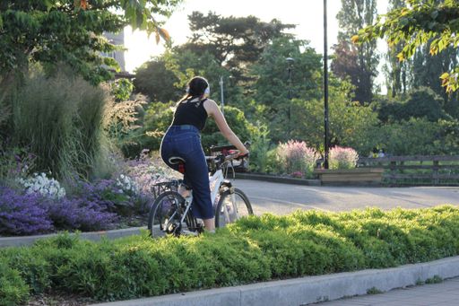 A young woman riding a bike on summer day in Vancouver