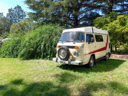 old white Volkswagen Type 2 T2 Kombi minibus van on the grass. Nature, plants, trees. Suda VW classic car show. Copyspace