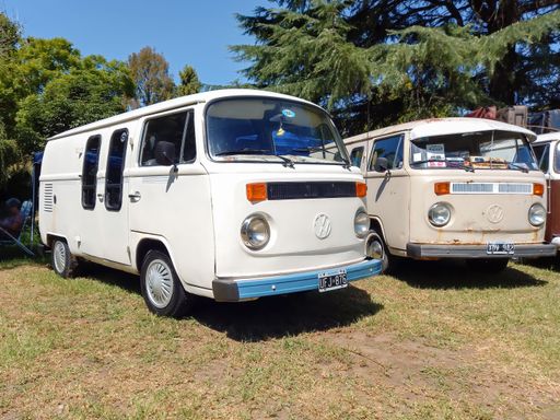 old white Volkswagen Type 2 T2 Kombi minibus vans parked on the grass. Suda VW classic car show. Copyspace
