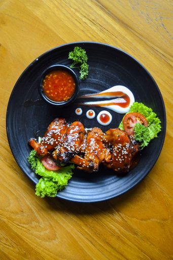 BBQ chicken wings with mayonnaise and chili sauce, a very popular restaurant menu for society who like grilled menu