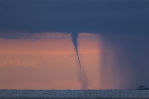 Water-spout in front of an advancing rain curtain, Associated with a dark, flat-bottomed developing cumuliform cloud.  Off  Ghadira Bay, Malta,