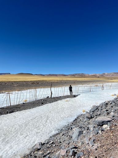 A man walking on the icy snow in the street in Catamarca, Argentina
