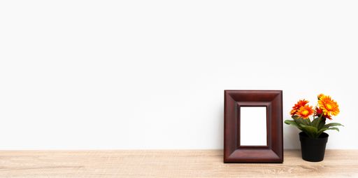 A shelf with a framework and a bouquet of flowers over white wall