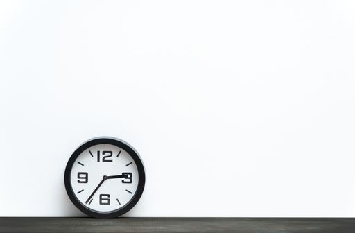 A shelf with wall clock on white background