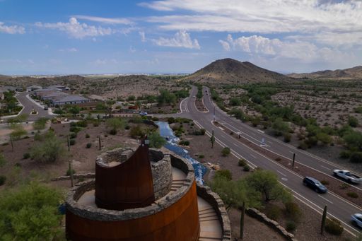 An aerial view of Estrella Star Tower by the highway in the countryside in Goodyear, Arizona
