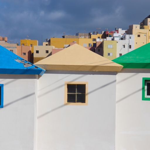 A beautiful shot of white buildings with colourful roofs and windows on a cloudy day
