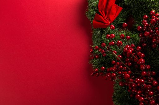 A Christmas red background decorated with garland