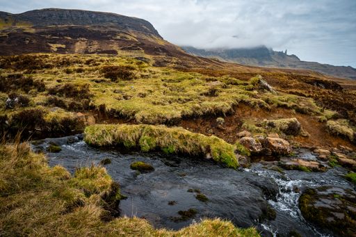 A beautiful waterfall flowing down the rocks covered in moss