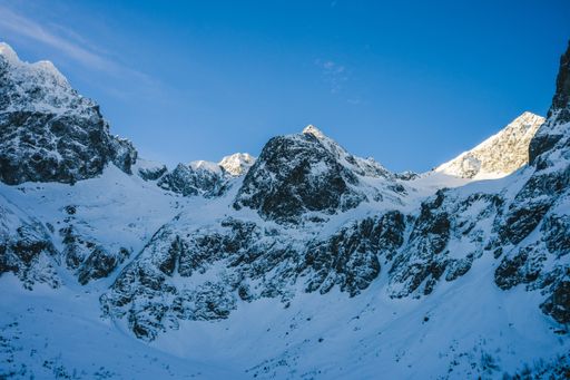 A breathtaking view of the magnificent mountains covered in snow under the blue sky in Slovakia