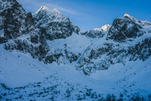 A breathtaking view of the magnificent mountains covered in snow under the blue sky in Slovakia