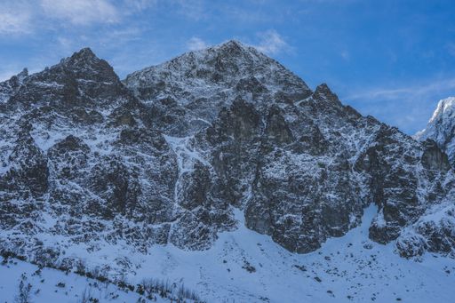 A breathtaking view of the magnificent mountains covered in snow under the blue sky in Slovakia