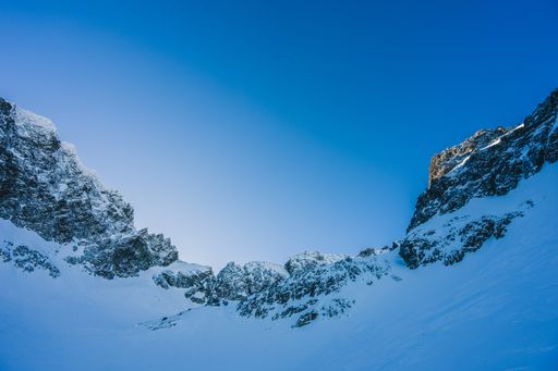 A breathtaking view of the magnificent mountains covered in snow under the blue sky in Slovakia