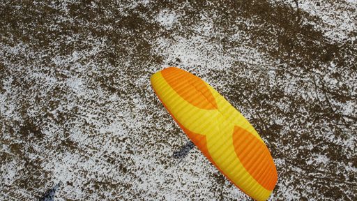 A paragliding over a snow meadow in Czech Republic