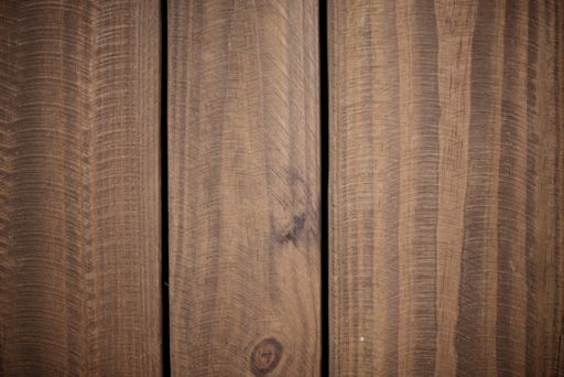A closeup shot of a wall made of vertical wooden planks - perfect for a cool wallpaper background