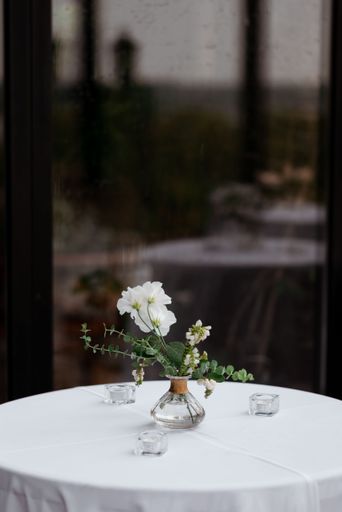 A beautiful flowers bouquet on a dining table with blur mirror in the background, vertical shot